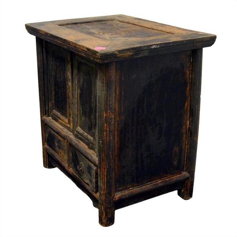 Dark wood Chinese side cabinet with rustic finish and drawer, vintage-style furniture close-up.
