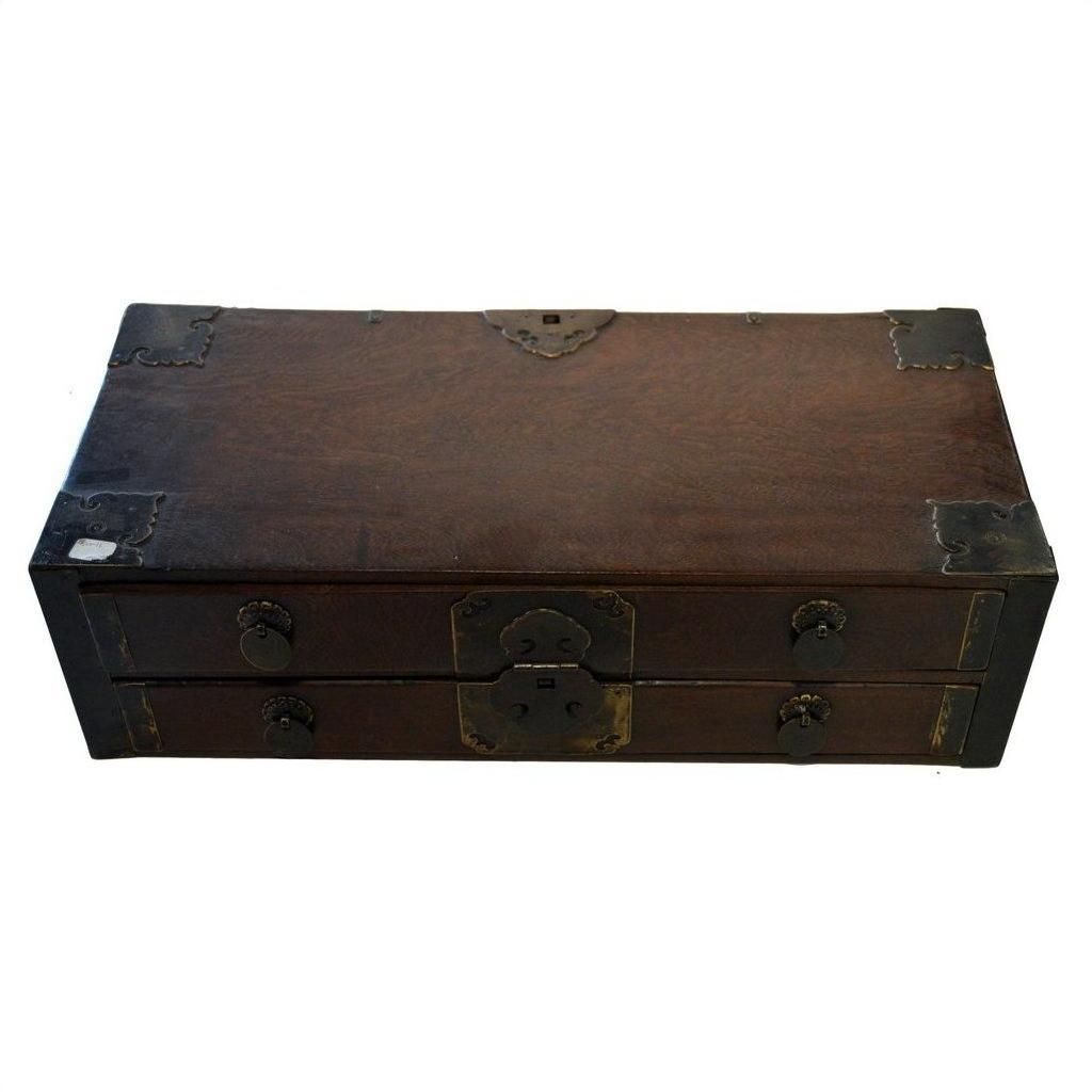 Small antique Chinese wooden chest with metal accents, latch, and two front drawers, close-up view.