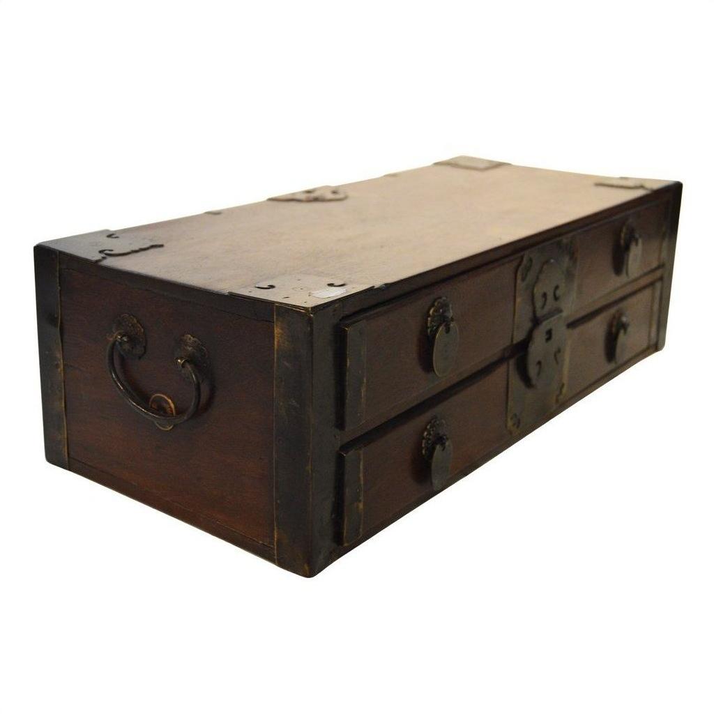 Dark wood Chinese chest with metal handles, two drawers, and decorative metal accents on front and corners, close-up.