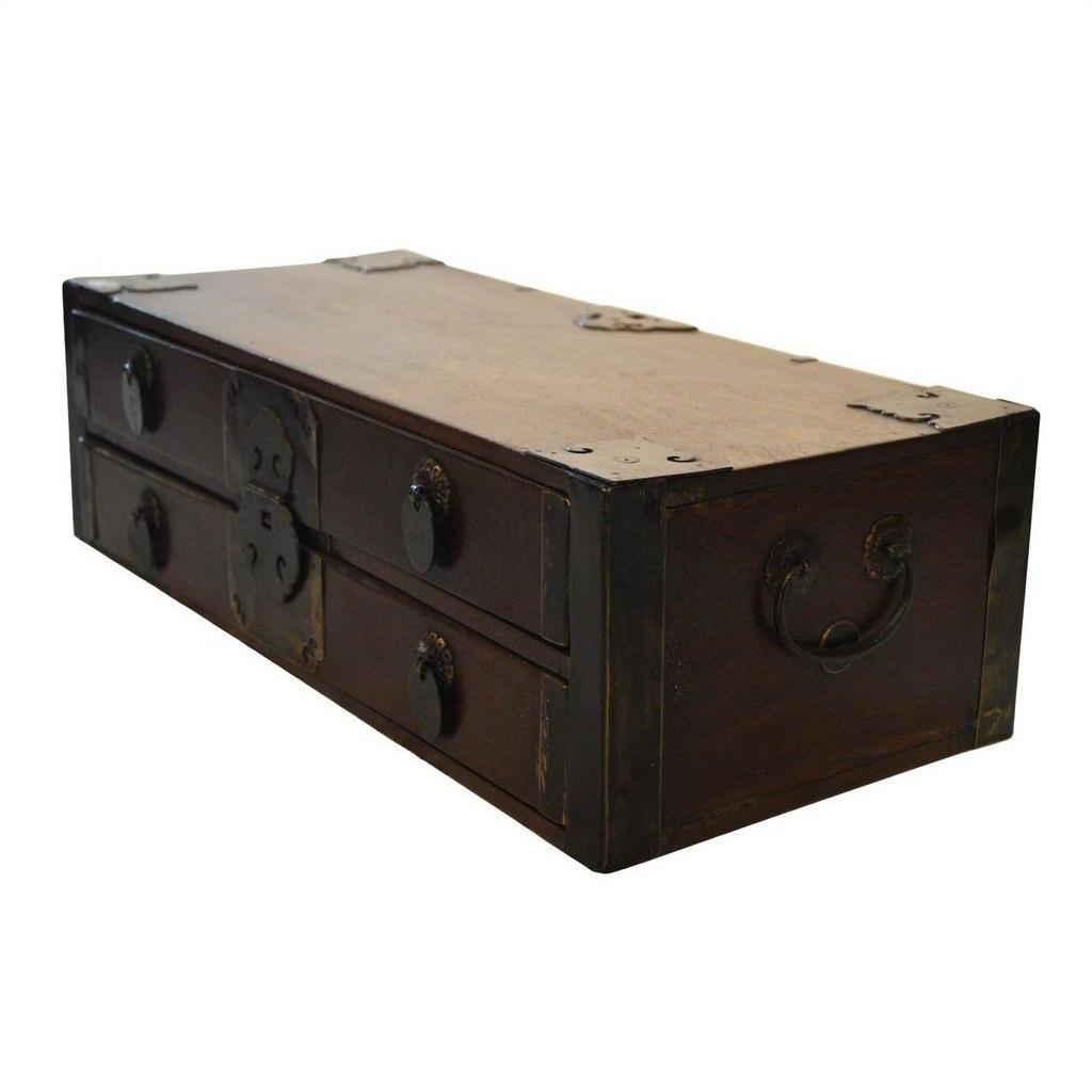 Small antique Chinese chest with metal accents, handles, and four drawers, wood finish, on a white background.