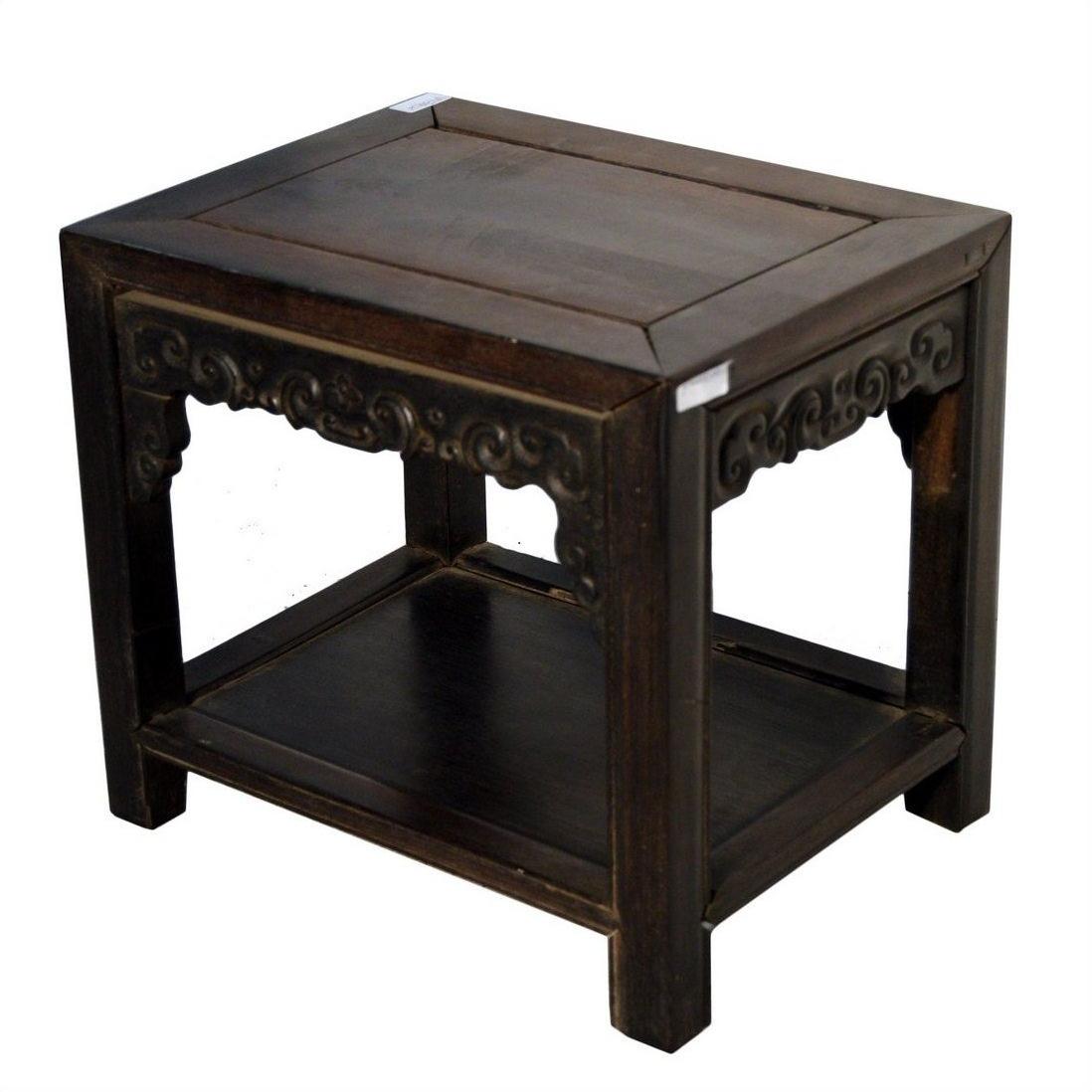 Small brown wood antique Chinese coffee table with hand-carved details and lower shelf, on white background.