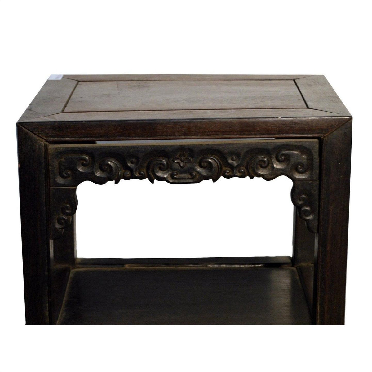 Brown wood antique Chinese coffee table with hand-carved front details and open lower shelf, white background.