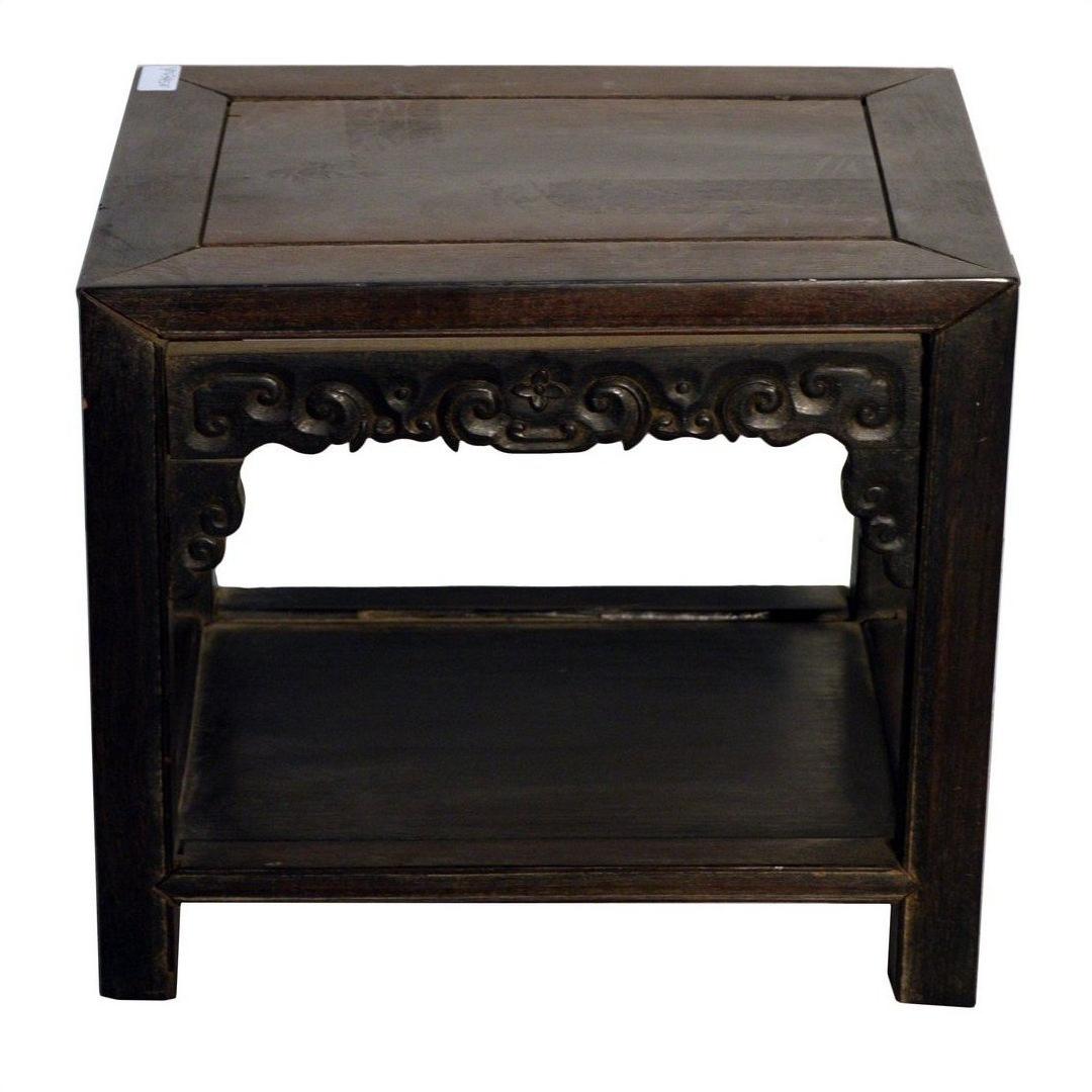 Dark wood Chinese coffee table with ornate hand-carved apron and lower shelf, front view on white background.
