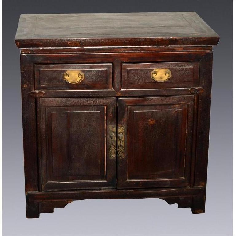 Small dark brown lacquered Chinese cabinet with brass handles, two drawers, and two doors, classic style.