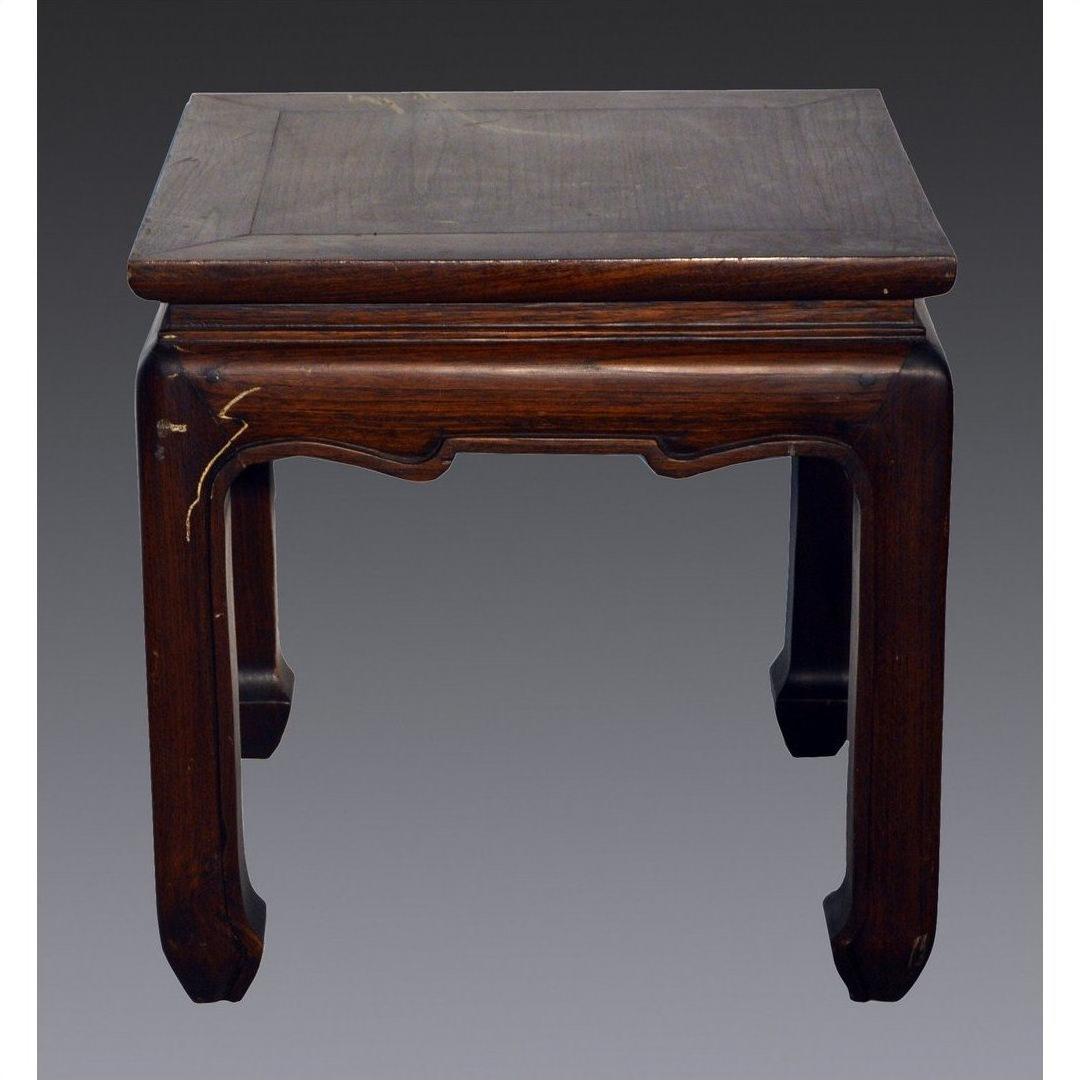 Dark wood Chinese antique square side table with horse hoof legs and crack on left front edge, gray background.