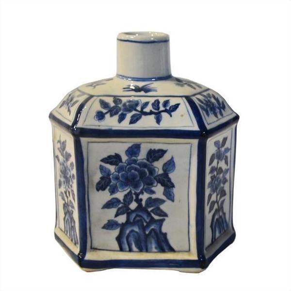 White ceramic hexagonal sake bottle with blue floral designs, antique Chinese Taisho, close-up view.
