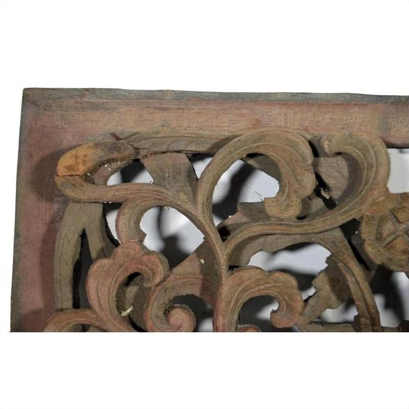 Close-up of antique Chinese temple carving with intricate floral and leaf patterns, white background.