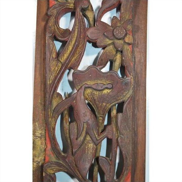 Close-up of antique Chinese vertical peony spray carving in warm natural wood, detailed floral design visible.