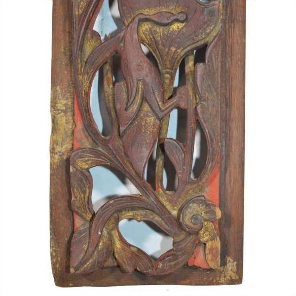 Close-up of antique Chinese wooden carving with vertical peony spray, floral and leaf motifs, faded gold accents.