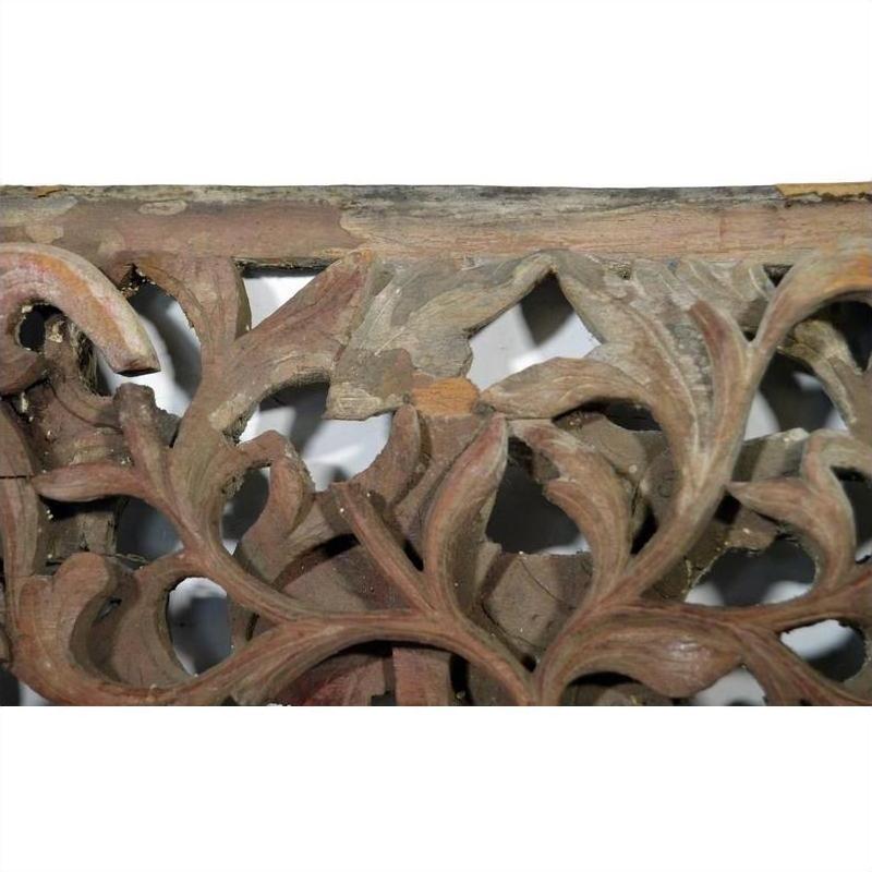 Close-up of antique wooden Chinese temple carving with intricate floral and leaf patterns, vintage detail visible.