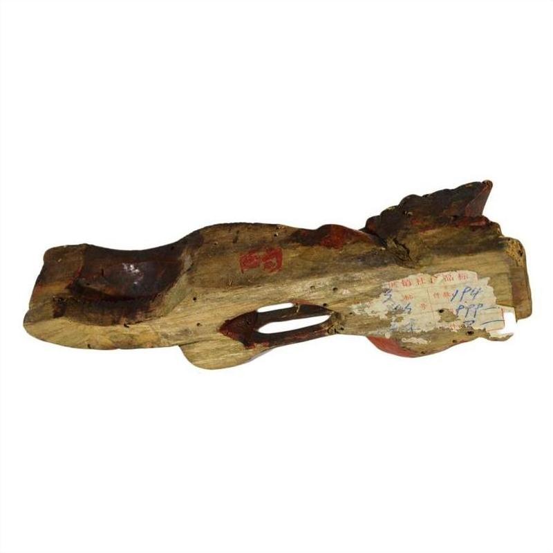 Brown wood antique Chinese temple carving with worn paint and faded labels, irregular abstract shape.