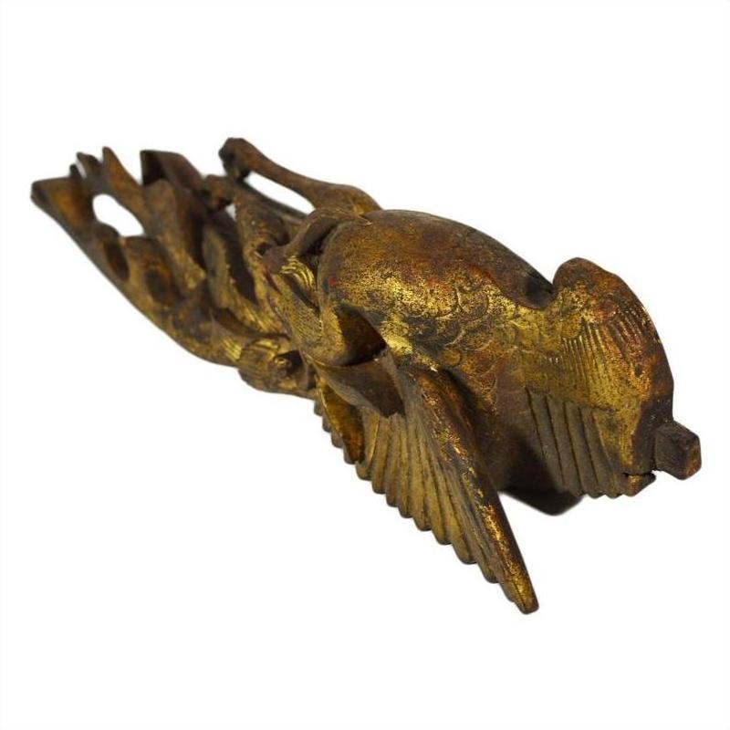 Antique wood Chinese temple carving with outstretched wings, diagonal view on white background.