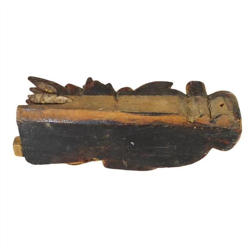 Brown wood antique Chinese temple carving on its side, plain white background.