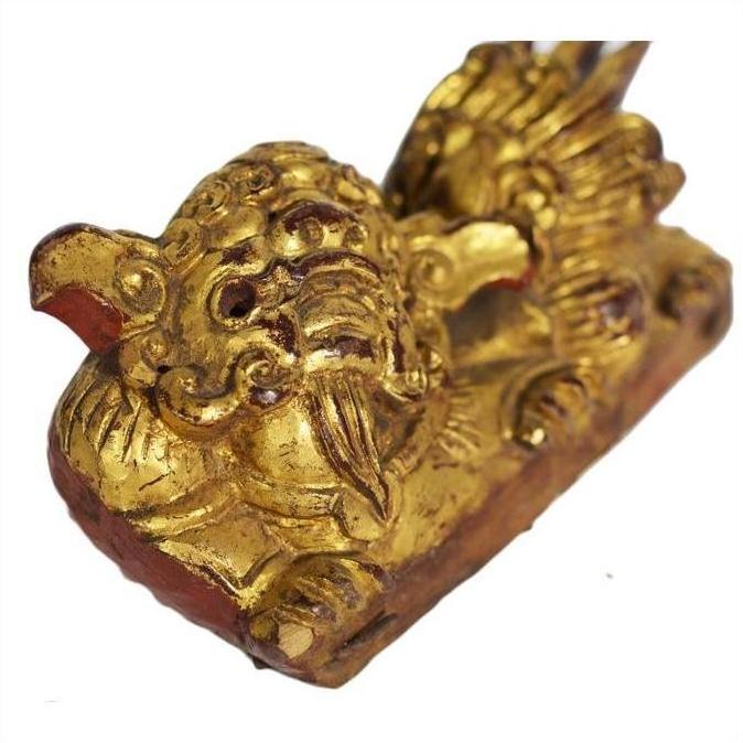 Close-up of dragon-shaped antique Chinese temple carvings, carved wood, pair on rectangular bases against white background.