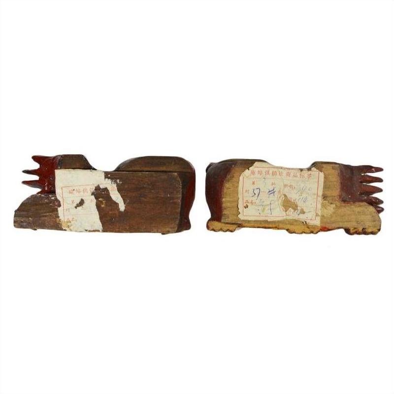Brown wood dragon-shaped Chinese temple carvings, antique pair side by side on white background.