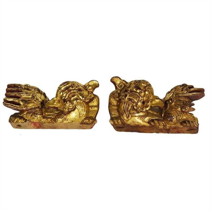 Antique Chinese dragon-shaped wood temple carvings, pair facing each other on a white background.