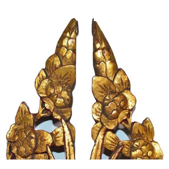 Close-up of gold antique Chinese temple carvings, ornate floral details, displayed on a plain white background.