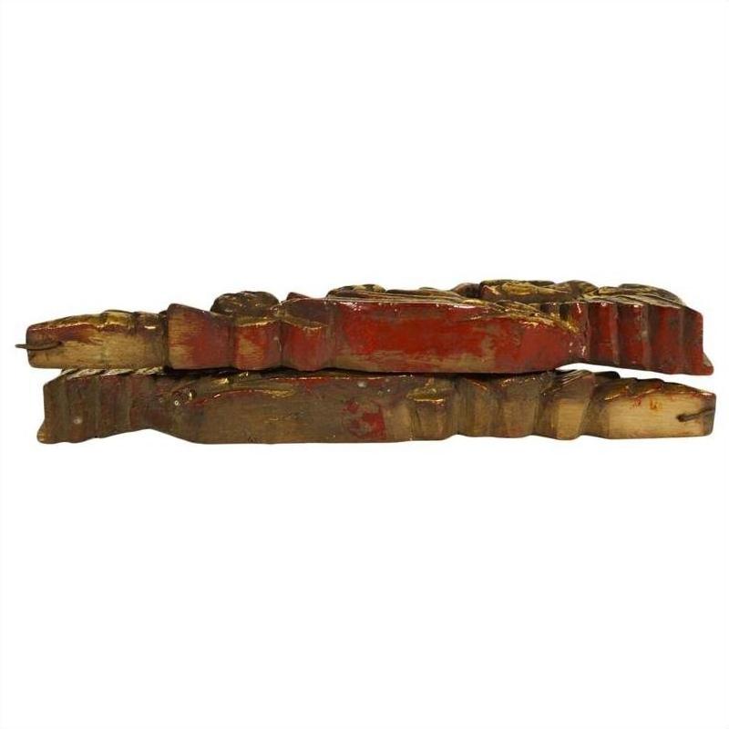 Red and gold wood temple carvings, antique, pair displayed side by side on white background.