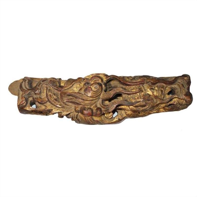 Gold and brown antique Chinese temple wood carvings with dragon motifs, close-up view.