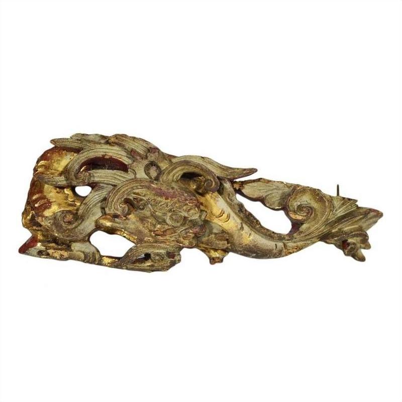 Close-up of gold and red wood Chinese temple carvings, featuring ornate mythical creatures and intricate detailing.