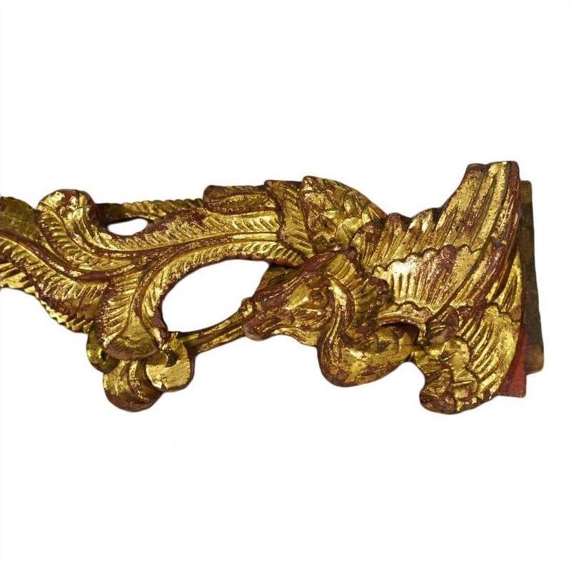 Pair of ornate antique Chinese temple carvings with intricate bird and leaf motifs on white background, close-up view.