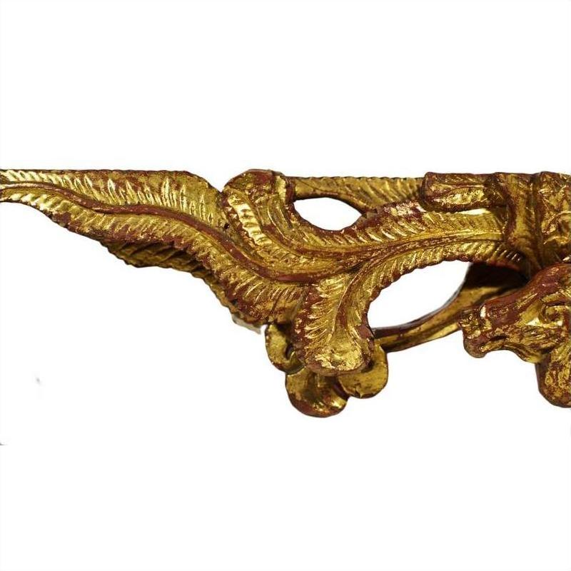 Close-up of gold and white antique Chinese temple carvings with swirling leaf patterns, pair shown.