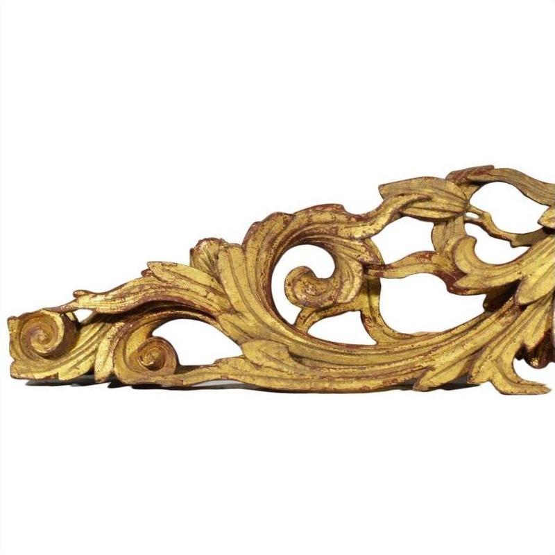 Gold wood antique Chinese temple carvings pair with ornate swirling leaf patterns and fine detailing, close-up view.