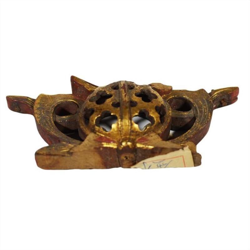 Gold and brown antique Chinese temple carvings with ornate floral patterns, front view.