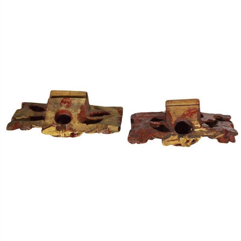 Gold and red wooden candle holders with ornate carvings, weathered finish, antique style, pair shown.