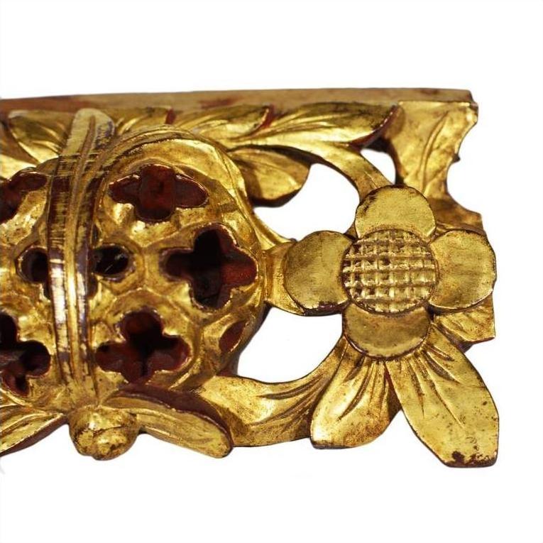 Close-up of gold-painted wood antique Chinese temple carvings with ornate floral and leaf designs, pair shown.