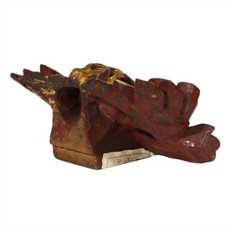 Red and gold wood carvings, pair, with wing-like designs on rectangular base, Chinese antique style.