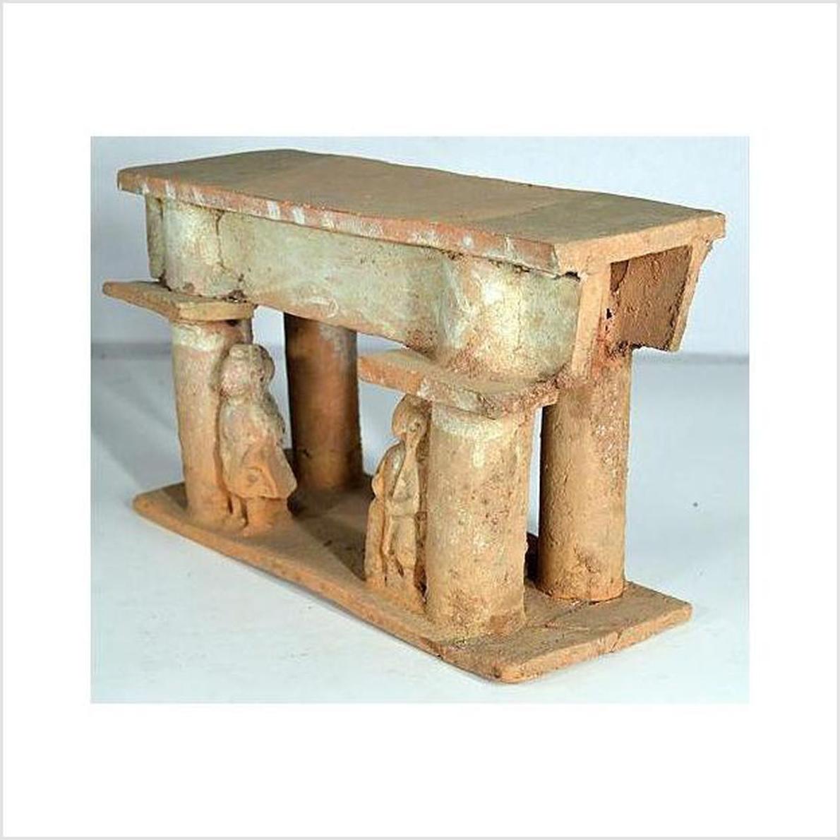 Brown terracotta clay model town gate with columns, flat roof, and two figures, 17th century Chinese style.