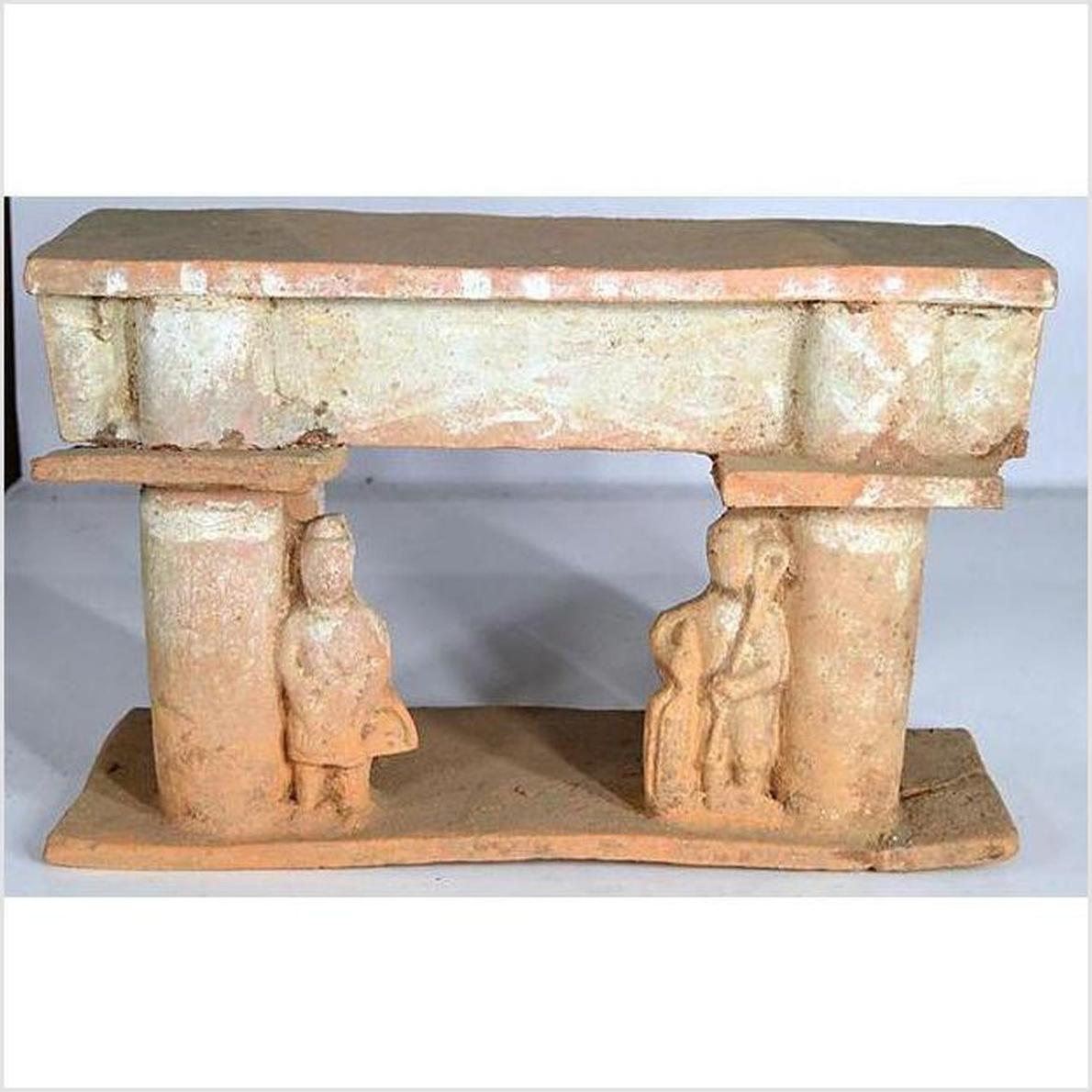Brown terracotta town gate with two human figures, rectangular roof, flat base, 17th century Chinese style.