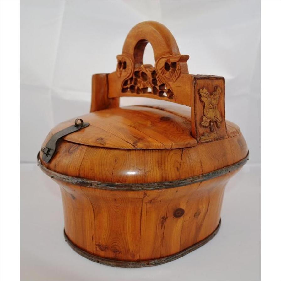 Brown wood Chinese wedding basket with carved handle, hinged lid, and metal rim accents on white background.