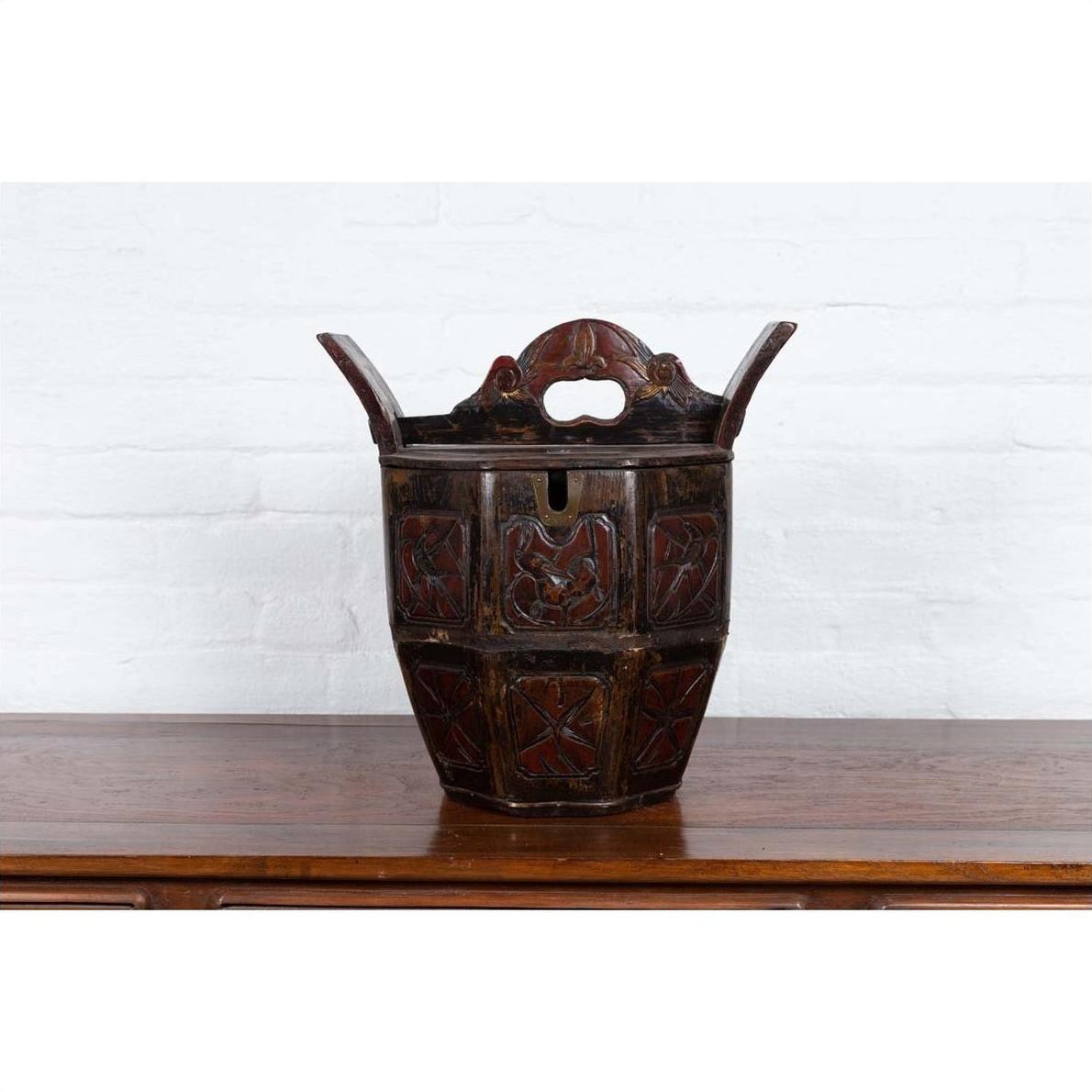 Brown wood wedding box with carved handle, animal and foliage motifs, on a table.