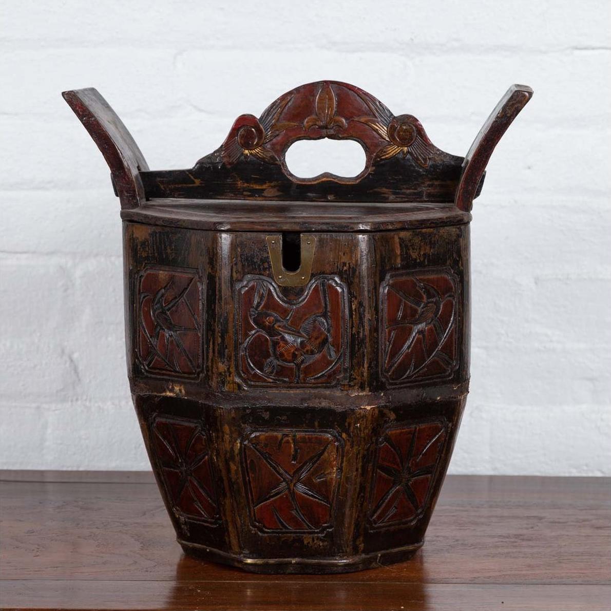 Brown wood Chinese wedding box with carved handle, animal and foliage motifs, shown indoors against a white wall.