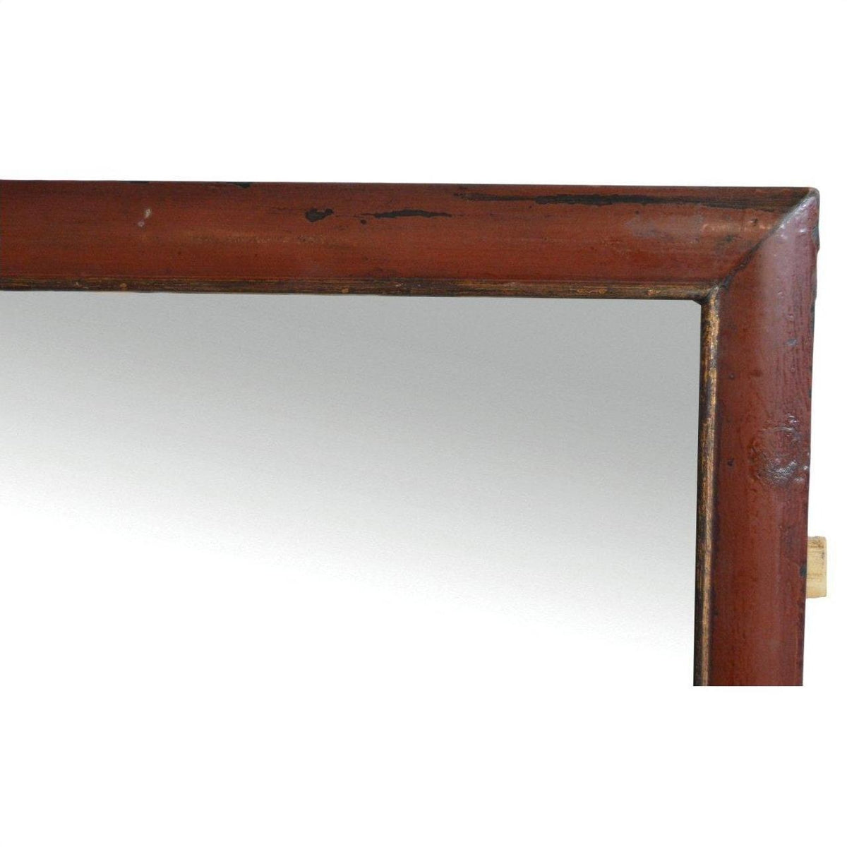 Close-up of the top right corner of a reddish-brown wooden framed Antique Classic Mirror.