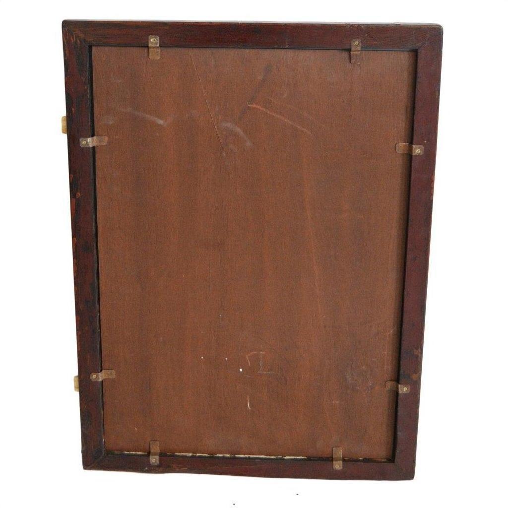 Close-up of visible clips securing the brown backing board on the reverse side of an antique classic mirror.
