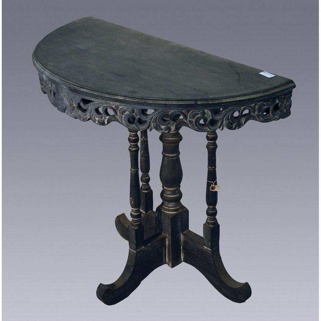 Brown wooden antique demi lune table with ornate carved edges and four turned legs, shown against plain background.