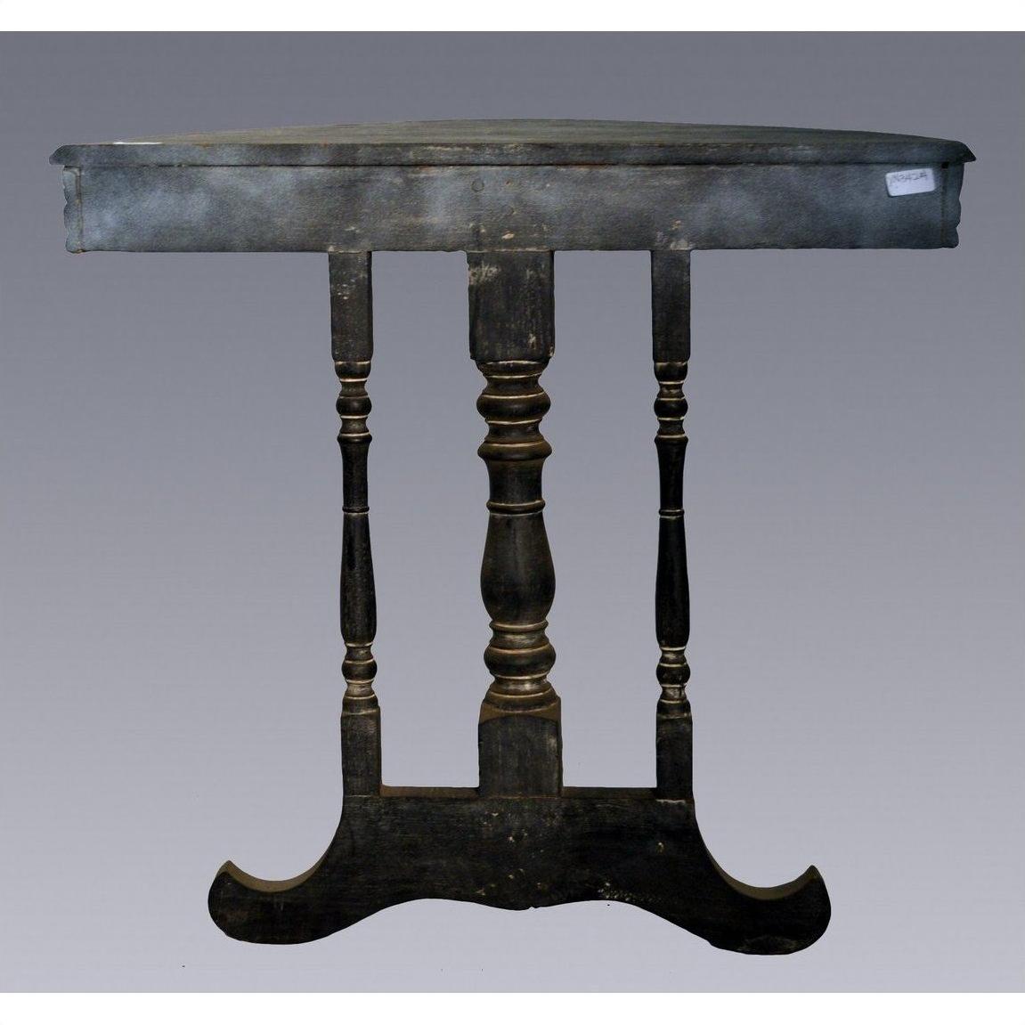 Weathered dark wood antique demi lune table with three turned legs, shown against a plain gray background.