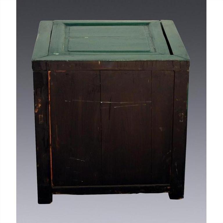 Green lacquer antique wooden cabinet with dark finish, classic Chinese style, close-up view.