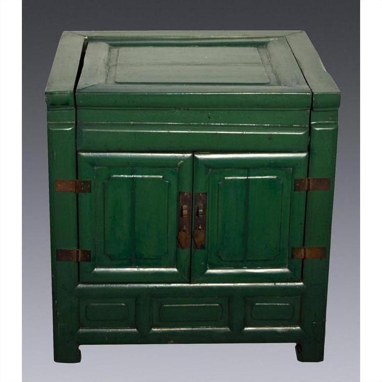 Antique green lacquer cabinet with two doors and metal hinges, set against a plain gray background.