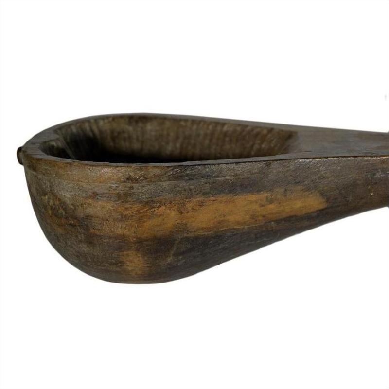 Brown hand-carved wooden Indian lute with deep rounded bowl and sturdy handle against a white background.