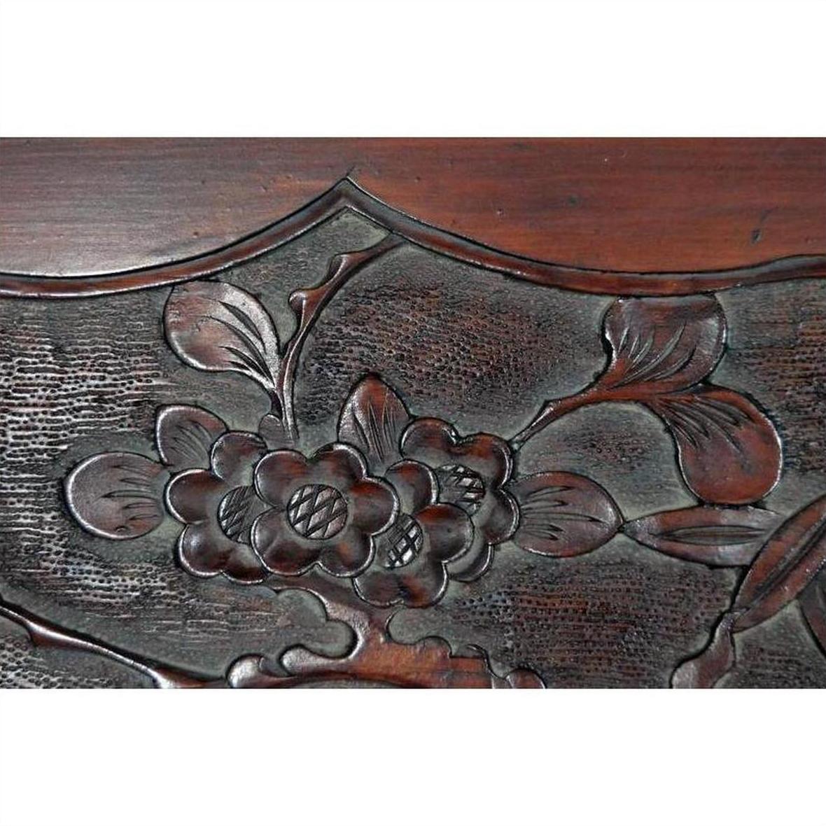 Close-up of dark rosewood wall plaque, hand-carved with lacquered finish and detailed 19th century Chinese floral relief.