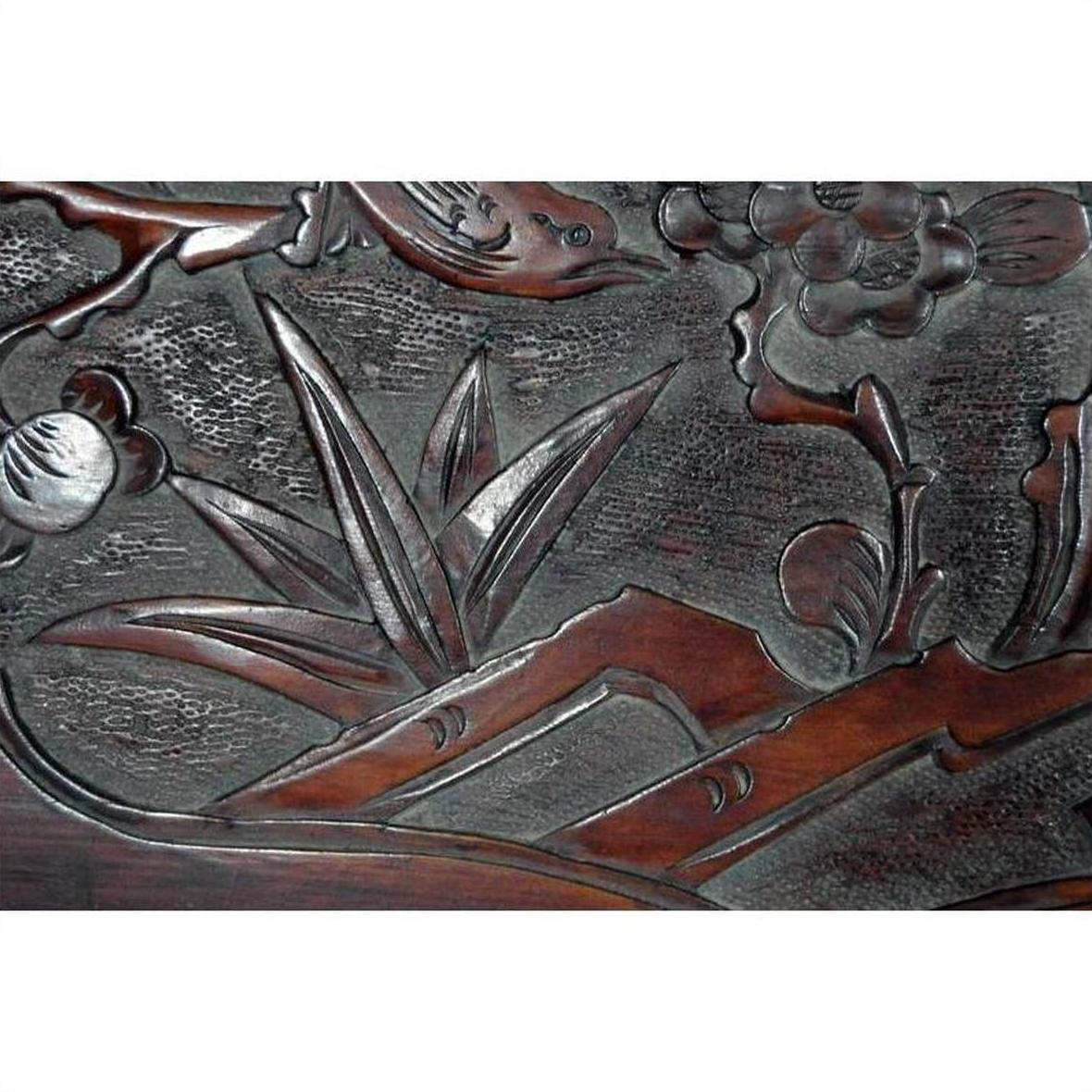 Dark rosewood wall plaque with hand-carved floral, leafy, and abstract natural patterns.