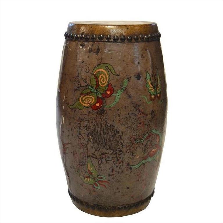 Close-up of a hand-painted brown ceramic Chinese antique drum with colorful butterfly designs and a beaded rim.