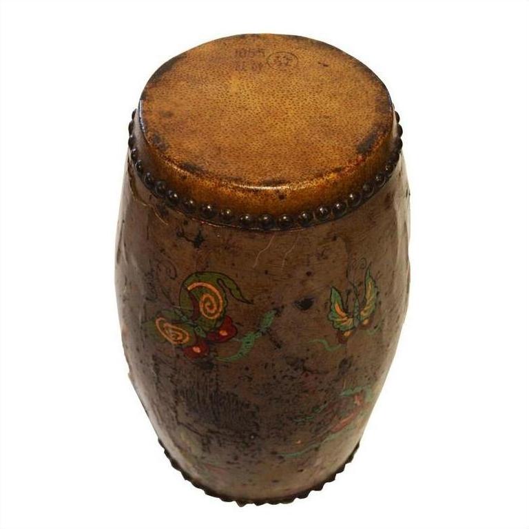 Close-up of antique hand painted Chinese drum with worn leather top and butterfly designs on wooden body.