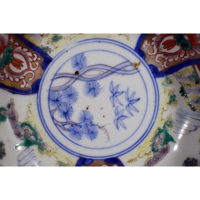 Close-up of blue and multicolored hand painted Japanese Imari porcelain bowls, set of 4, floral border designs.