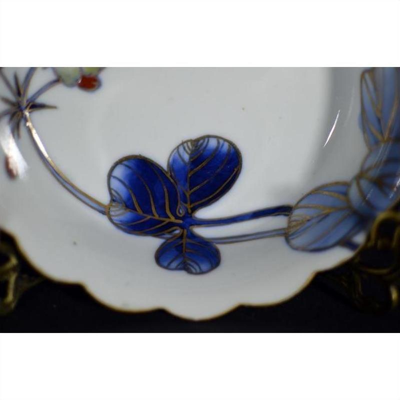 Blue and gold hand-painted Japanese Imari porcelain bowls, set of 4 with scalloped edges, close-up view.