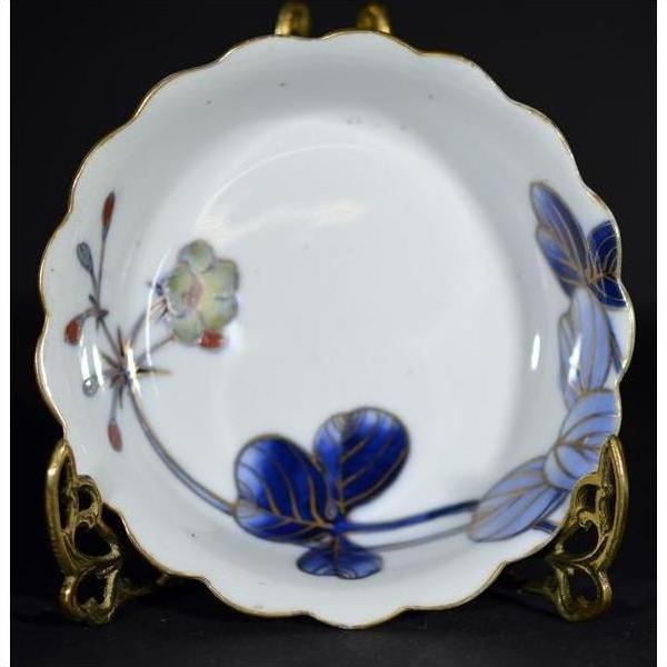 Set of 4 blue and gold hand painted Japanese Imari porcelain bowls with scalloped edges, close-up on white background.